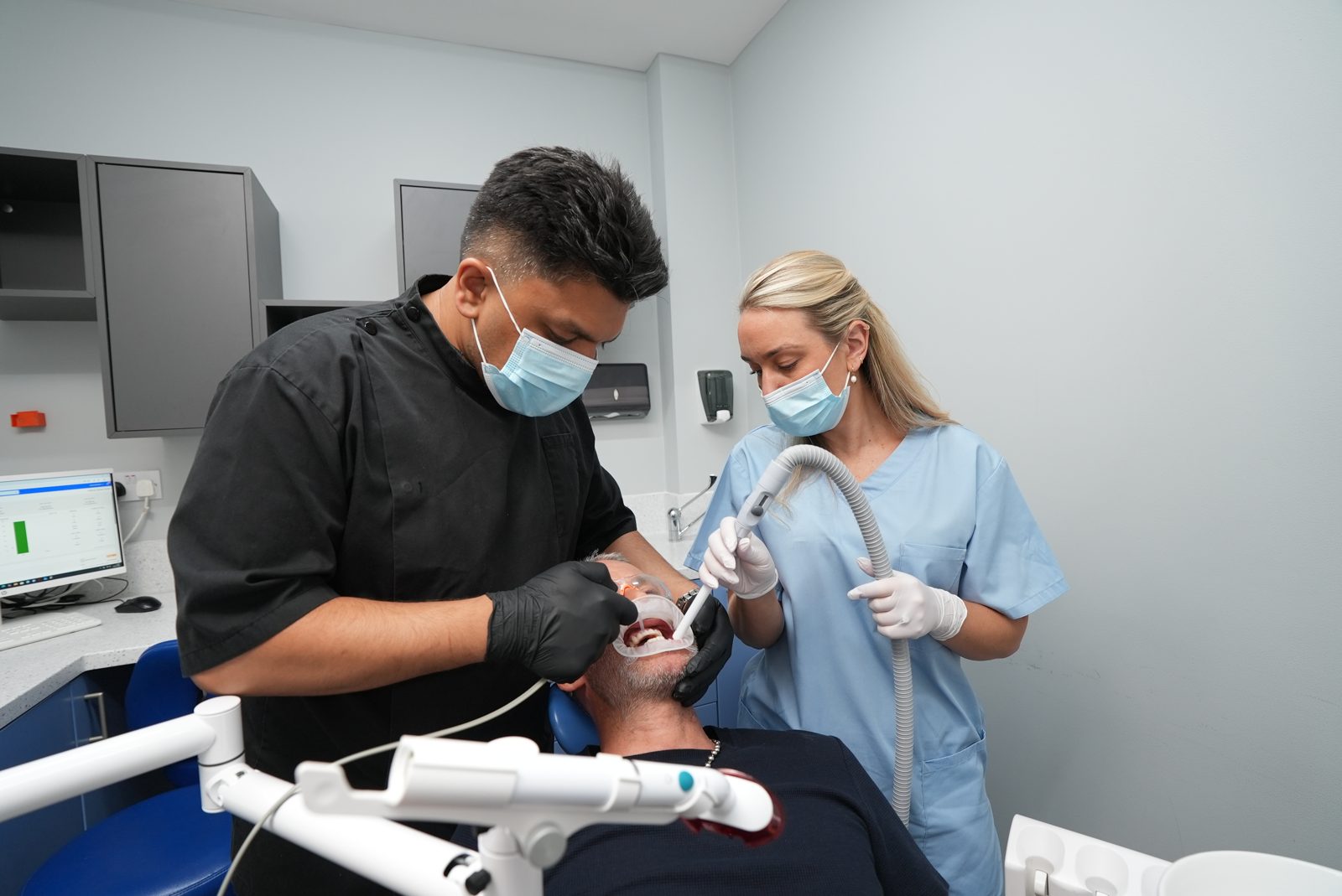 Dentist and nurse carrying out treatment at Welling Dental Studio
